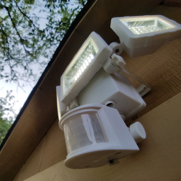 Solar powered security light mounted outside.